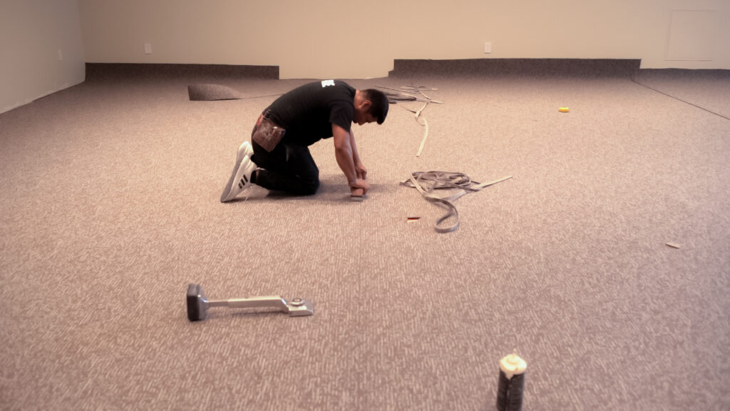 Carpet installation being done by a professional from El Nino Carpet and Flooring at a La-Z-Boy Home Furnishings store in Etobicoke, Ontario