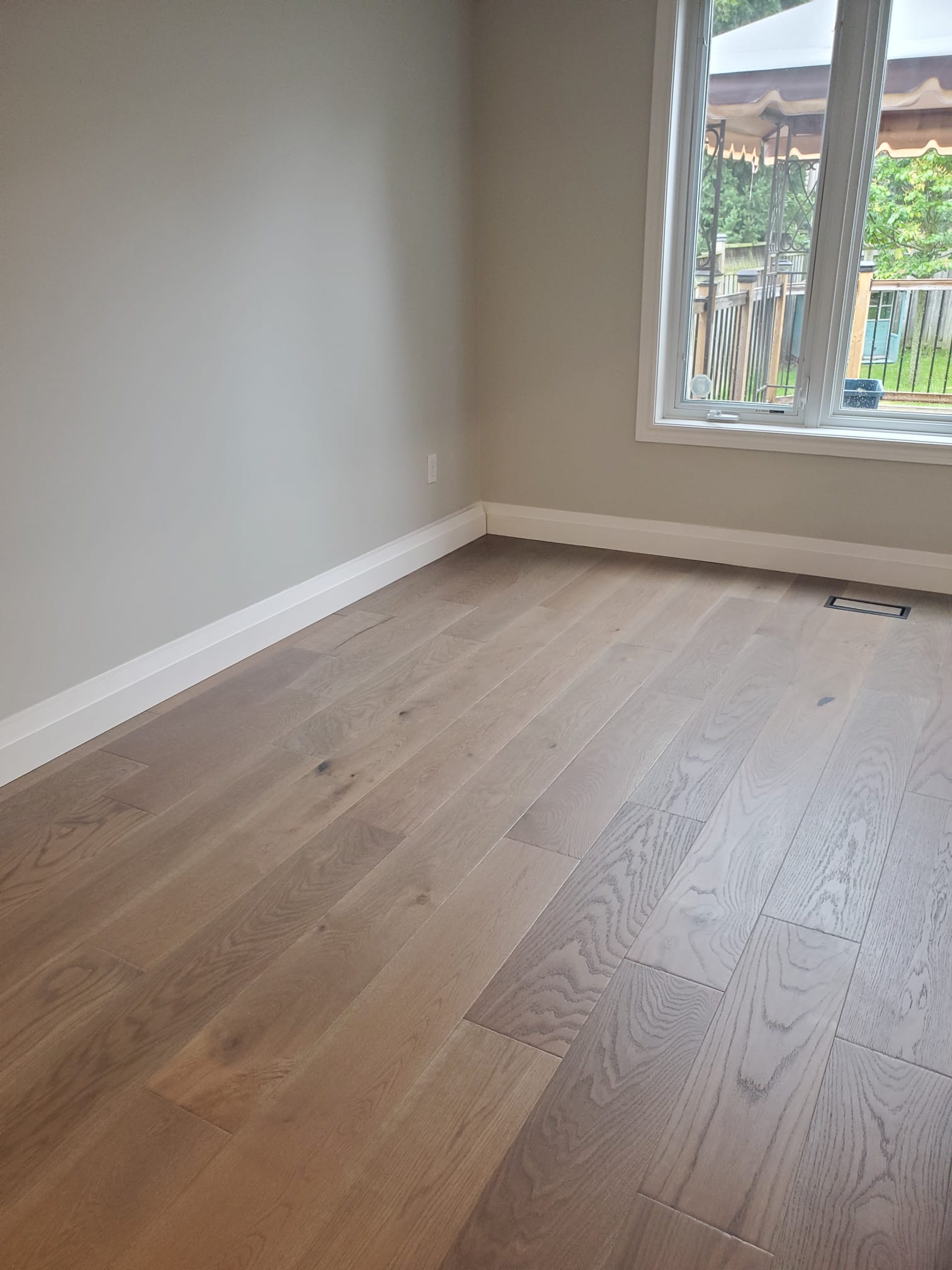 Canadian Standard in colour Webster hardwood installed in a home's living room by El Nino Carpet and Flooring